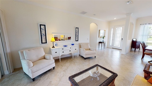 sitting room featuring crown molding and decorative columns