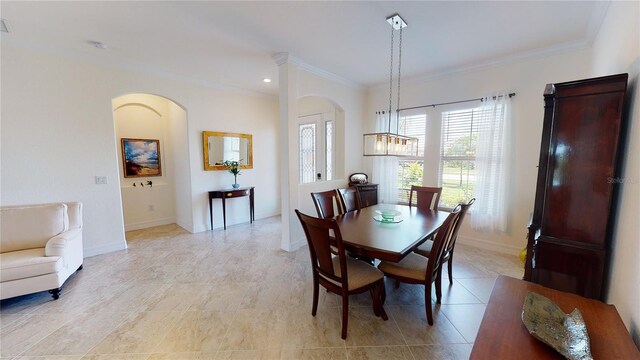 dining room with ornamental molding and light tile patterned flooring