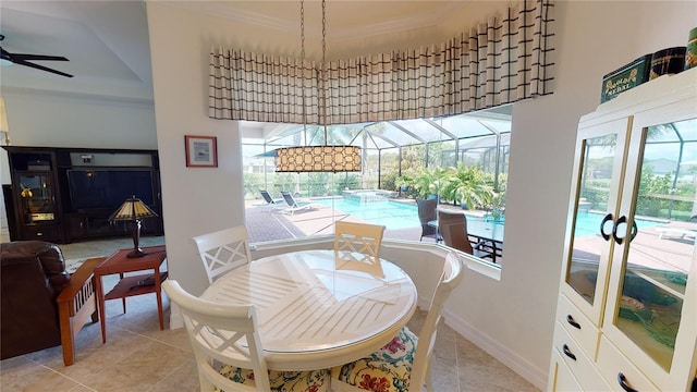 dining space with light tile patterned flooring, ceiling fan, and crown molding