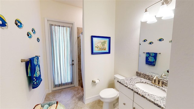 bathroom with vanity, tile patterned floors, and toilet