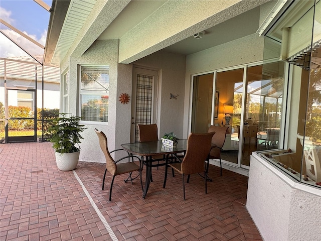 view of patio / terrace featuring glass enclosure