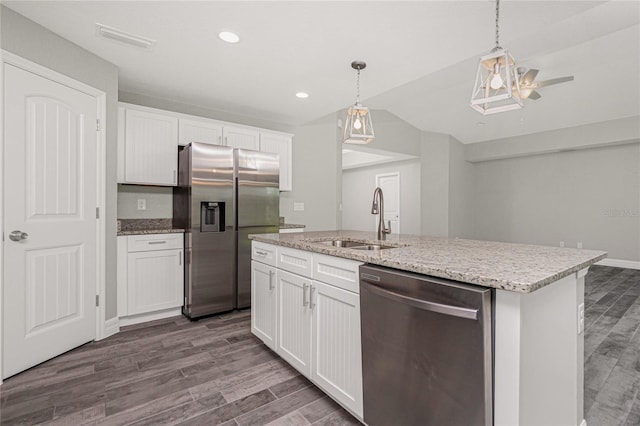 kitchen with a center island with sink, sink, white cabinets, and stainless steel appliances