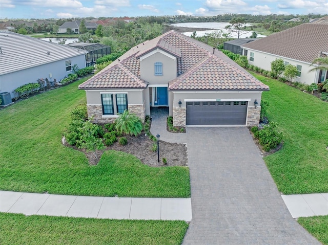 view of front of property with central AC, a front lawn, and a garage