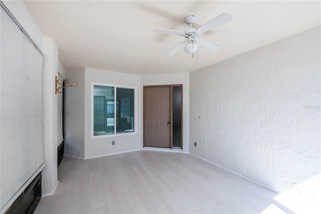 interior space with ceiling fan and light hardwood / wood-style flooring