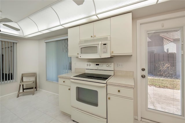 kitchen with a wealth of natural light, white appliances, and ceiling fan