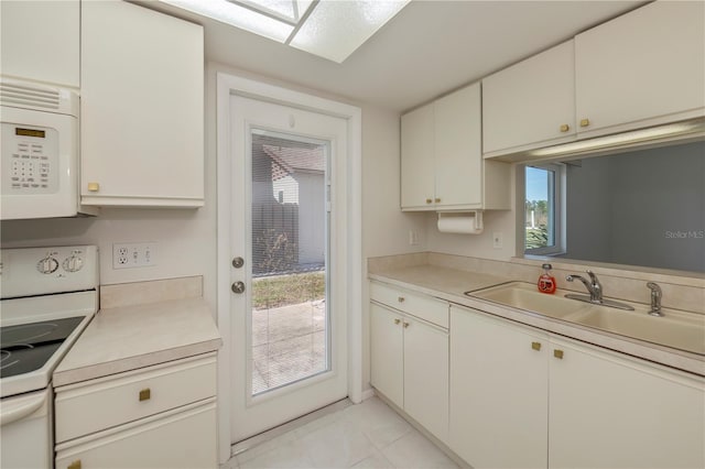 kitchen with a wealth of natural light, white cabinetry, and white appliances