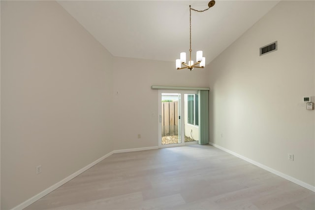 unfurnished room featuring high vaulted ceiling, an inviting chandelier, and light wood-type flooring