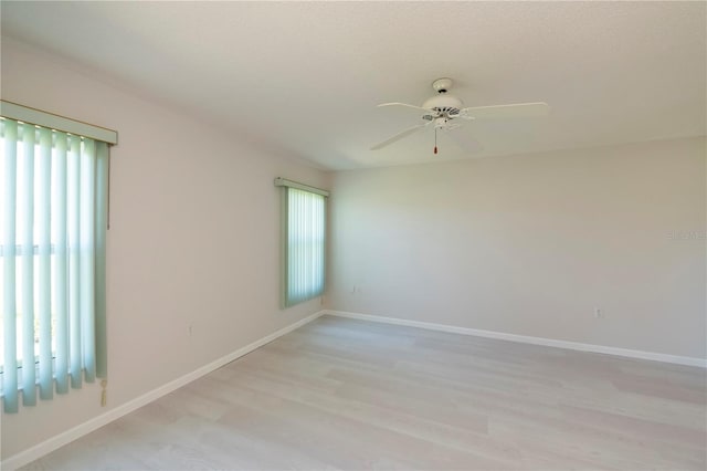 empty room with light wood-type flooring and ceiling fan