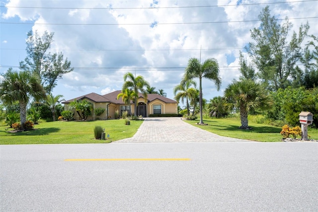 mediterranean / spanish house featuring a front lawn