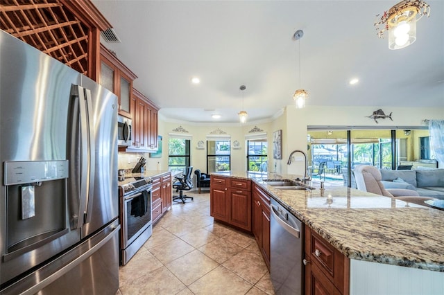 kitchen featuring ornamental molding, stainless steel appliances, sink, hanging light fixtures, and light tile patterned flooring