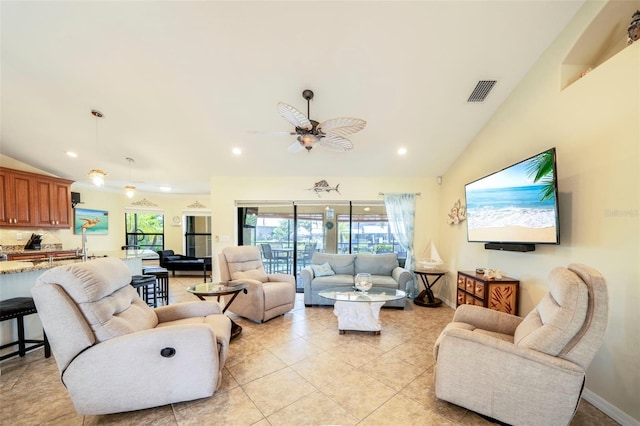 living room featuring ceiling fan, light tile patterned floors, and vaulted ceiling