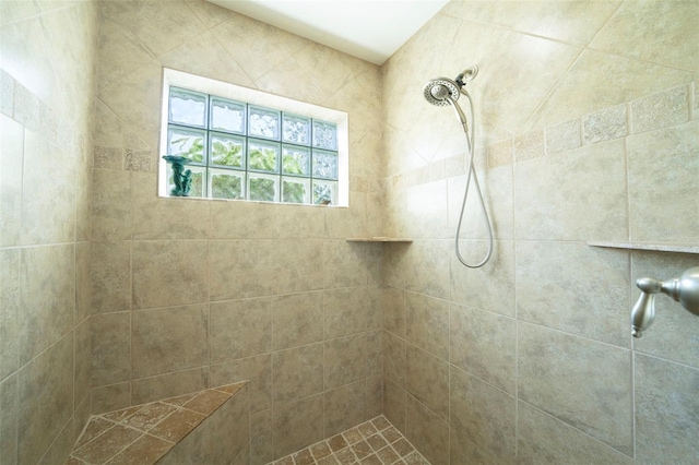 bathroom with tiled shower