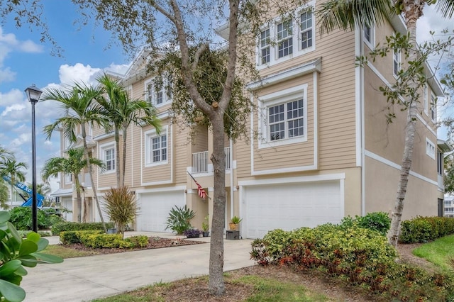 10311 Lands End Cir Unit 13, Placida, FL 33946 - view of property with a garage, driveway, and stucco siding