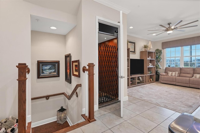 living room featuring crown molding, light tile patterned flooring, and ceiling fan