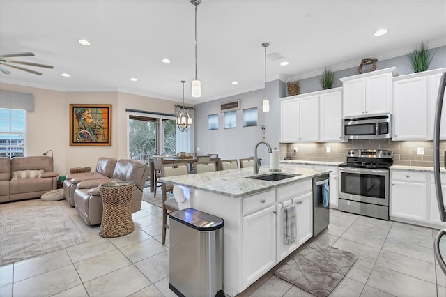 10311 Lands End Cir Unit 13, Placida, FL 33946 - kitchen featuring a sink, stainless steel appliances, backsplash, open floor plan, and plenty of natural light