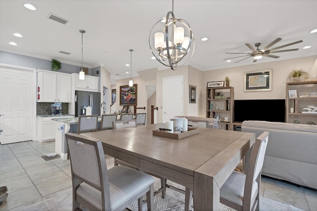 dining area featuring crown molding, light tile patterned flooring, and ceiling fan with notable chandelier