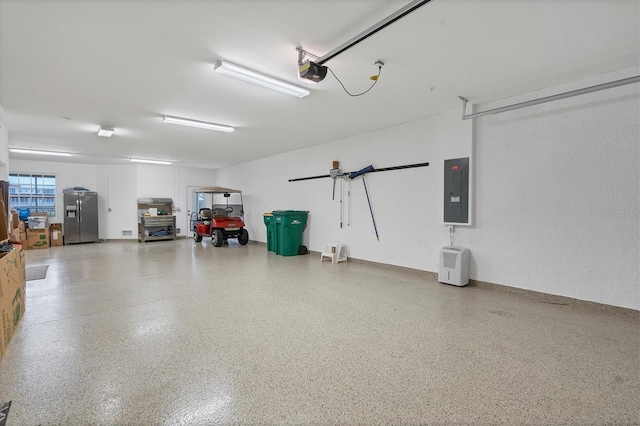 garage featuring electric panel, a garage door opener, and stainless steel fridge with ice dispenser