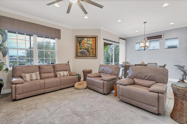 tiled living room with ornamental molding, ceiling fan with notable chandelier, and a healthy amount of sunlight