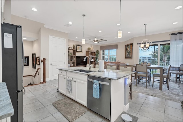 kitchen featuring appliances with stainless steel finishes, white cabinetry, a kitchen island with sink, and a healthy amount of sunlight