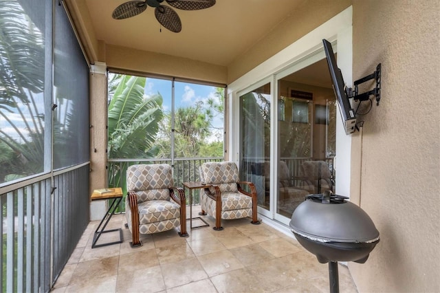 sunroom featuring ceiling fan