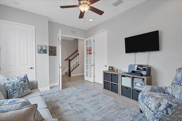 living room featuring ceiling fan and light hardwood / wood-style floors