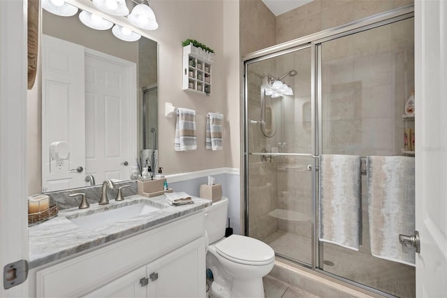 10311 Lands End Cir Unit 13, Placida, FL 33946 - bathroom with a shower stall, toilet, tile patterned floors, and vanity
