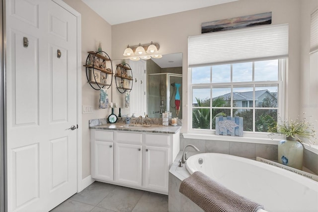 10311 Lands End Cir Unit 13, Placida, FL 33946 - bathroom with a stall shower, a bath, vanity, and tile patterned flooring