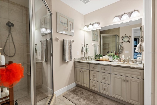 10311 Lands End Cir Unit 13, Placida, FL 33946 - bathroom with a stall shower, double vanity, tile patterned flooring, and baseboards