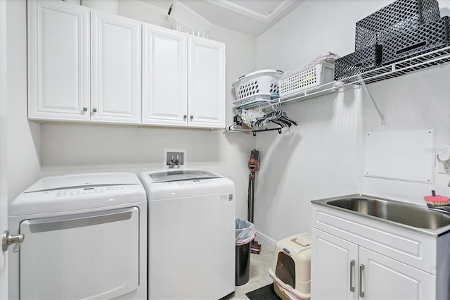 clothes washing area featuring independent washer and dryer and cabinets