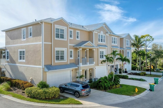 townhome / multi-family property with a balcony and a garage