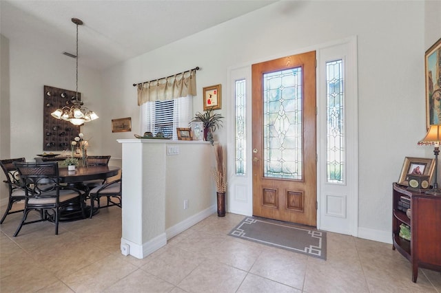 entrance foyer with an inviting chandelier, a healthy amount of sunlight, and light tile patterned floors