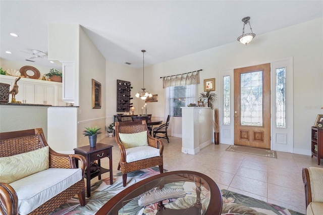 tiled entrance foyer featuring ceiling fan with notable chandelier