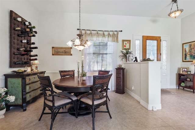 dining space featuring light tile patterned flooring and an inviting chandelier