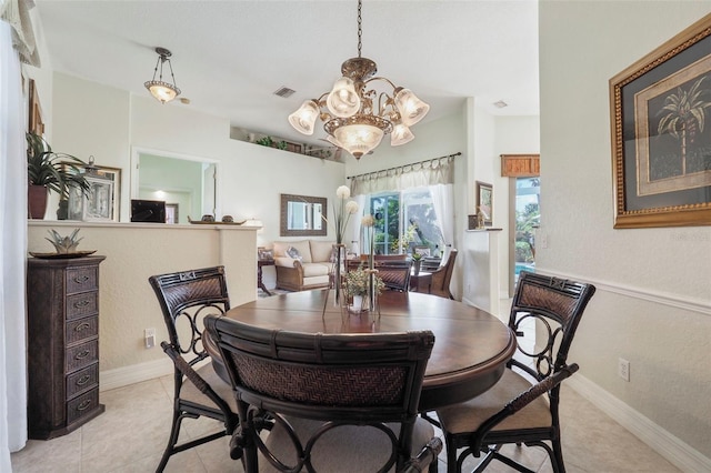 tiled dining area with an inviting chandelier