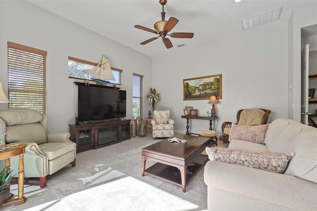 carpeted living room with ceiling fan