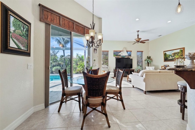 dining area with light tile patterned floors and ceiling fan with notable chandelier