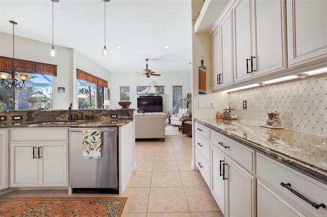 kitchen featuring dishwasher, white cabinets, hanging light fixtures, and dark stone countertops