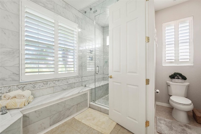 bathroom with toilet, walk in shower, and tile patterned flooring