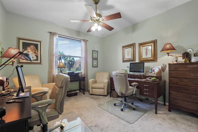 carpeted home office featuring ceiling fan