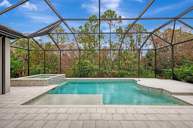 view of pool with a lanai, a patio area, and a pool with connected hot tub