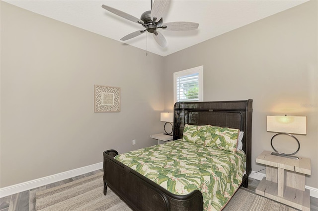 bedroom with baseboards, ceiling fan, and wood finished floors