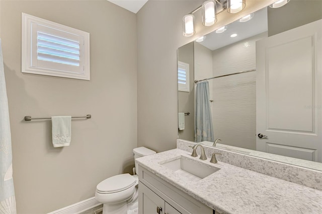 bathroom featuring walk in shower, vanity, and toilet