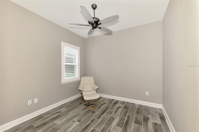 unfurnished room featuring baseboards, a ceiling fan, and wood finished floors
