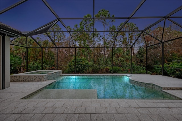 view of pool with a lanai and a pool with connected hot tub