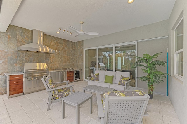 sunroom / solarium featuring wine cooler, ceiling fan, outdoor lounge area, and an outdoor kitchen