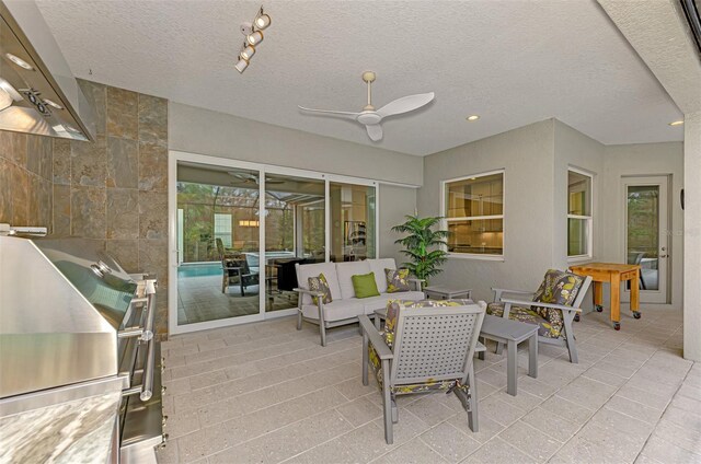 view of patio / terrace with grilling area, ceiling fan, and an outdoor living space