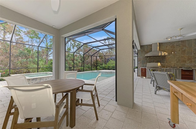 exterior space featuring outdoor dining space, exterior kitchen, a jacuzzi, ceiling fan, and a swimming pool