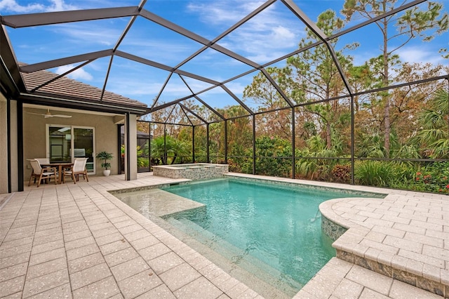 view of swimming pool featuring a patio, a lanai, ceiling fan, and an in ground hot tub