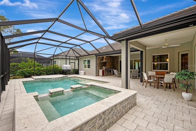 view of swimming pool featuring a patio, glass enclosure, ceiling fan, and an in ground hot tub