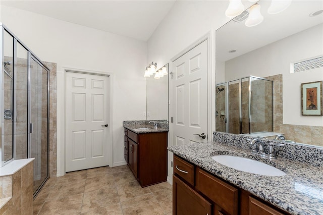 bathroom with tile patterned flooring, vanity, and a shower with door